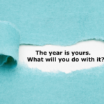 paper revealing the words "this year is yours, what will you do with it?"