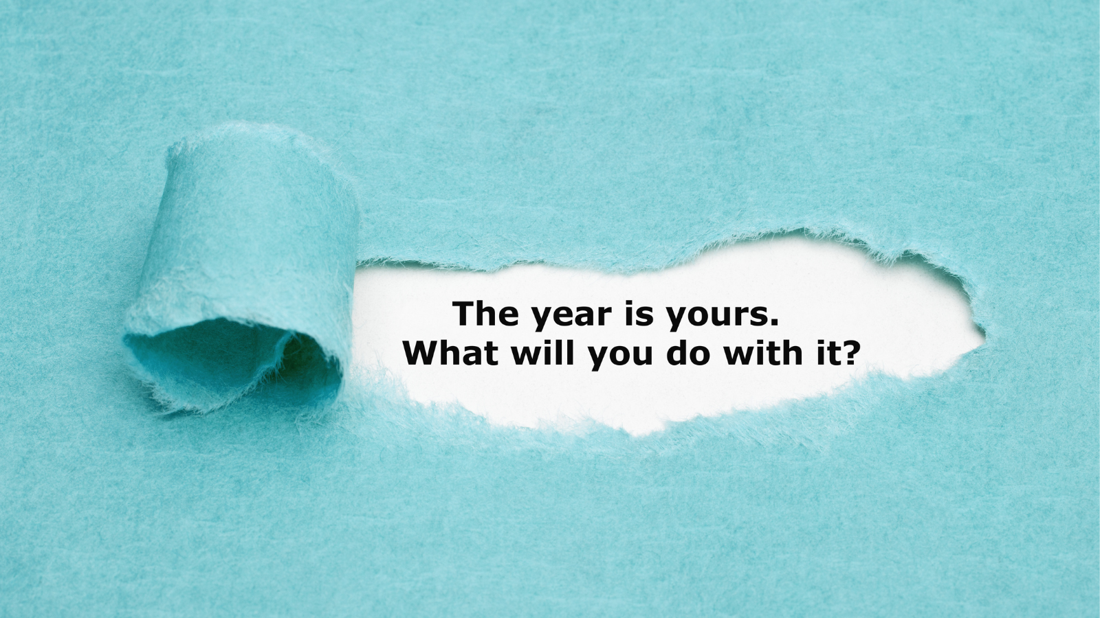 paper revealing the words "this year is yours, what will you do with it?"